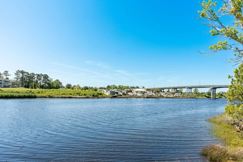a view of a body of water with a bridge in the background