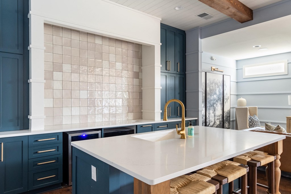 a kitchen with blue cabinets and a white counter top