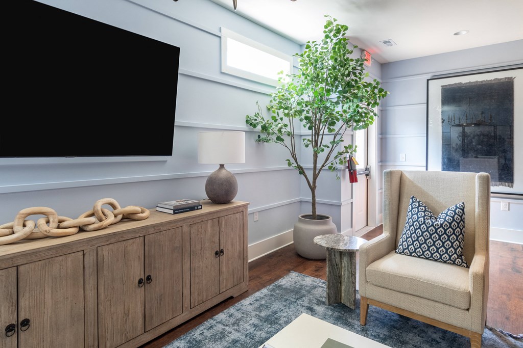 a living room with a large tv on the wall