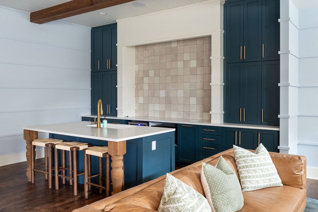 a kitchen with navy blue cabinets and a white countertop