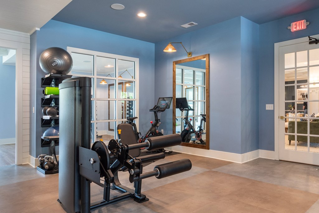 a home gym with exercise equipment and a large mirror