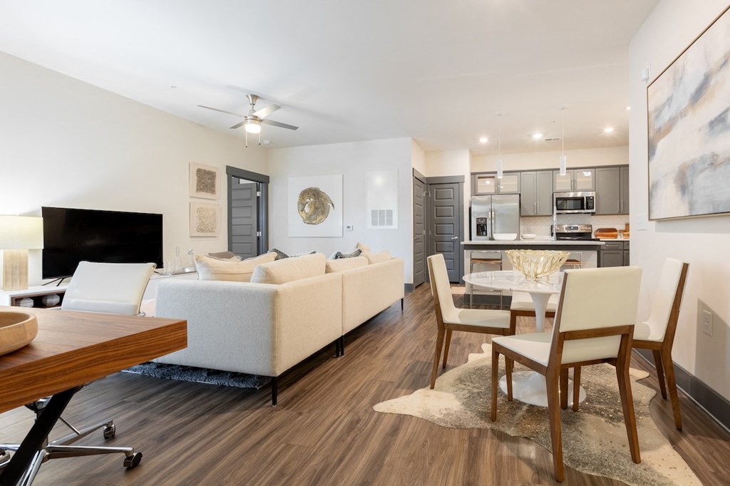 a living room with a couch and a table with chairs
