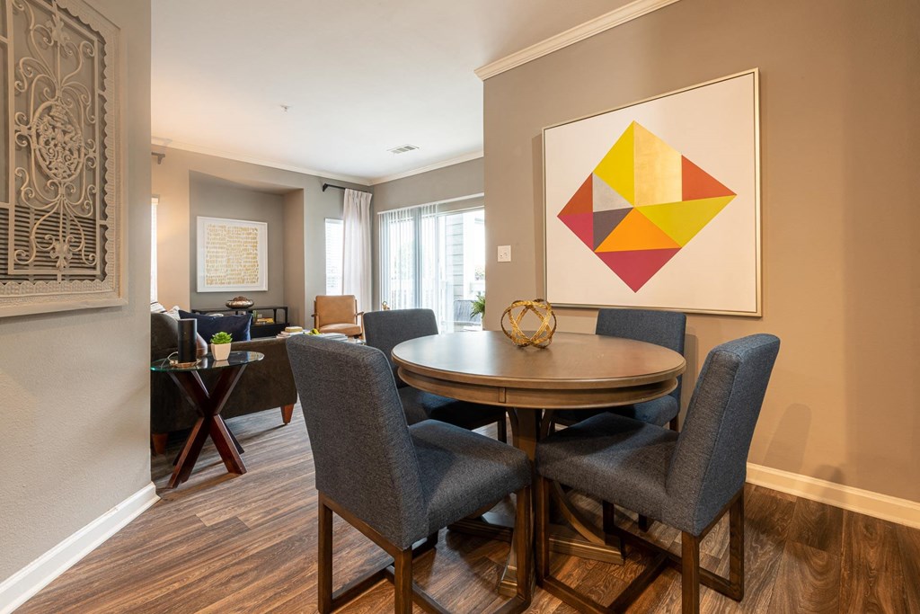 a dining room with a table and chairs