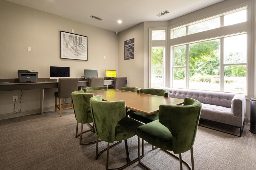 a conference room with a table and chairs and a couch