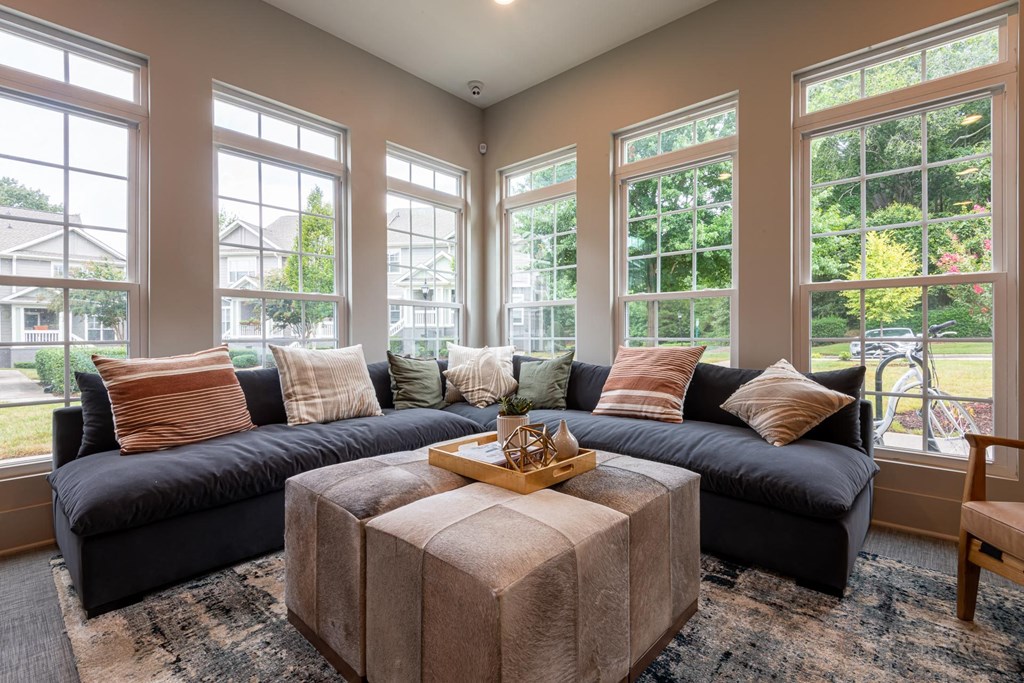 a living room with large windows and a large couch