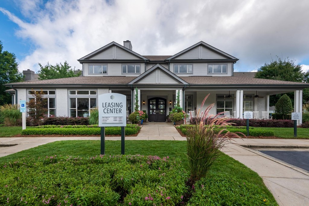 leasing center sign in front of a large house