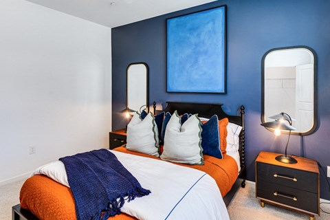 a bedroom with blue walls and a bed with pillows