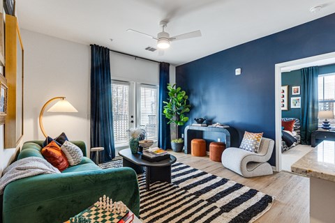 a living room filled with furniture and blue walls