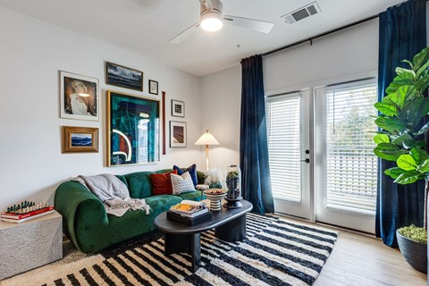 a living room with a green couch and a coffee table