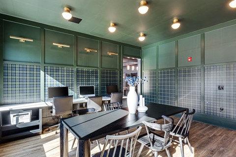 a conference room with a table and chairs and green walls