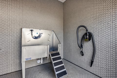 a bathroom with a shower and a fire hose