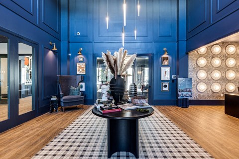 a lobby with blue walls and a black and white checkered floor