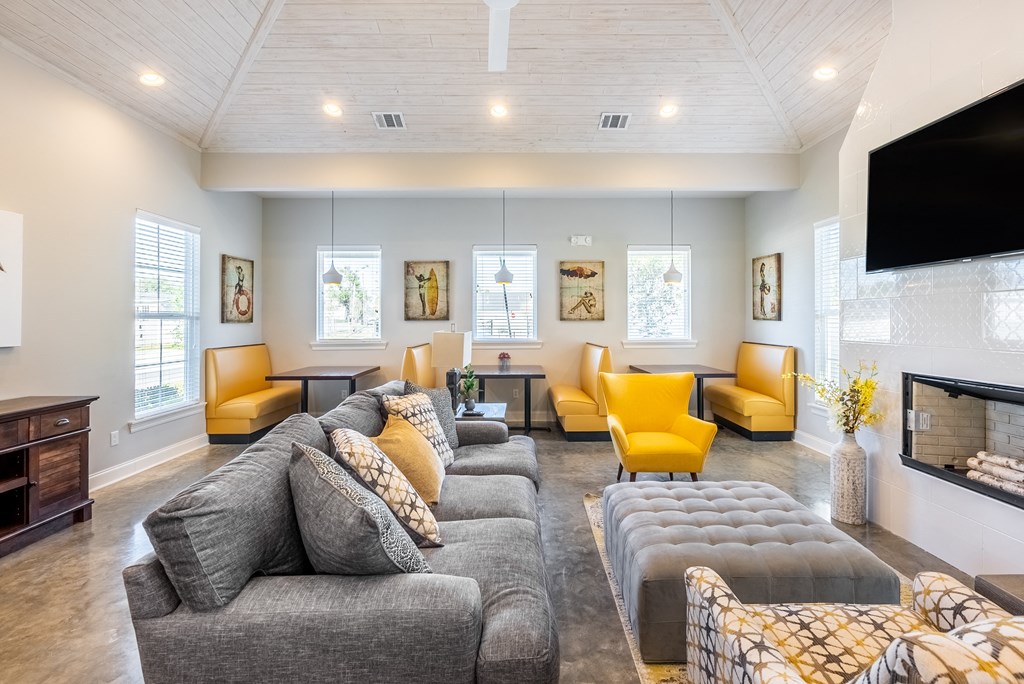 a living room with couches and chairs and a television