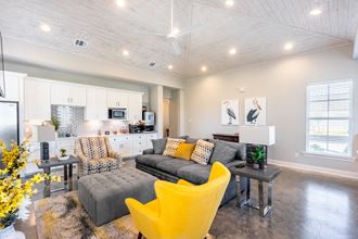 a living room with yellow chairs and a gray couch