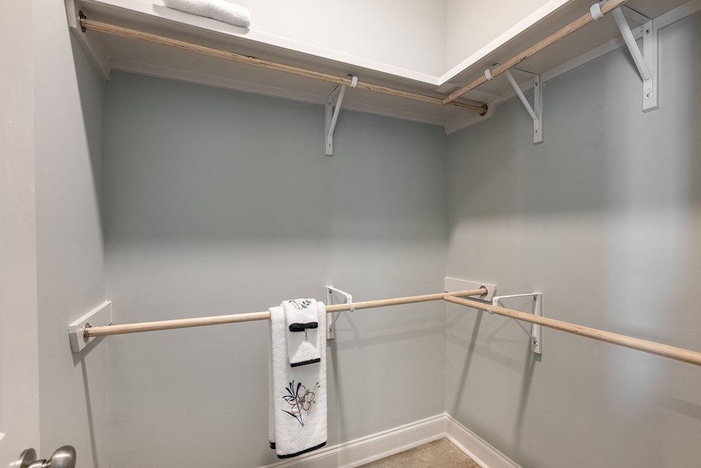 a bathroom with a mirrored wall and a towel rack on the wall