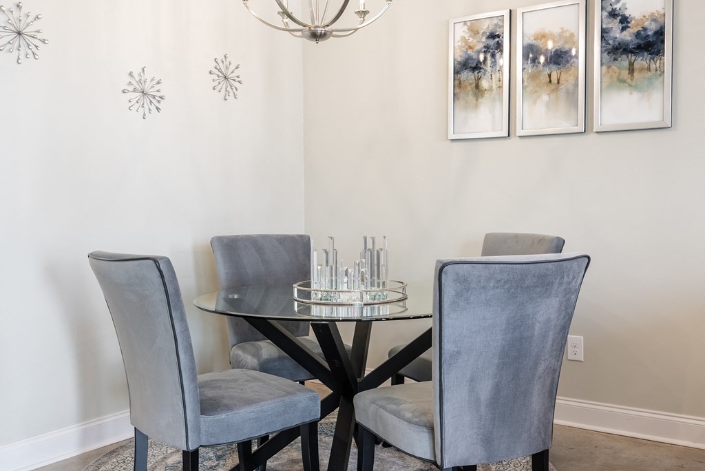 an image of a dining room with a table and chairs