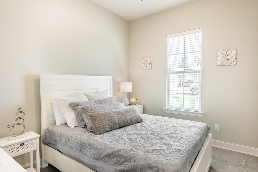 a bedroom with a bed and a window