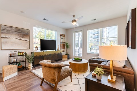 A living room with a brown chair and a brown couch.