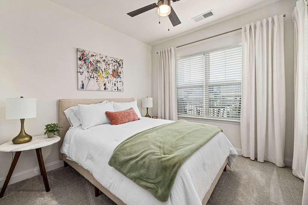 a bedroom with a bed and a ceiling fan