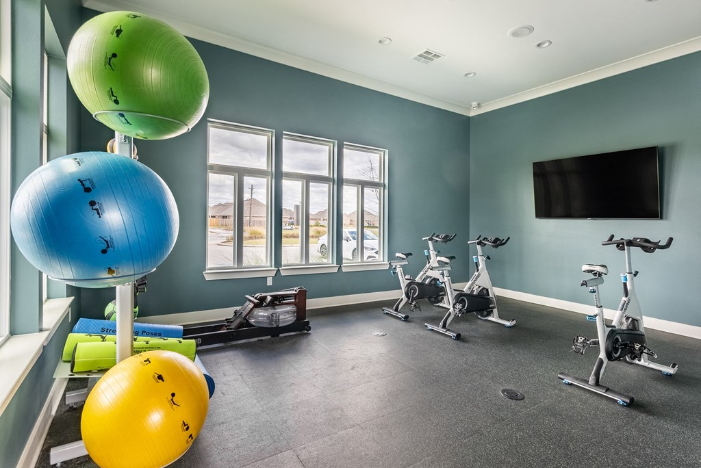 gym with exercise balls and windows at the district flats apartments in lenexa