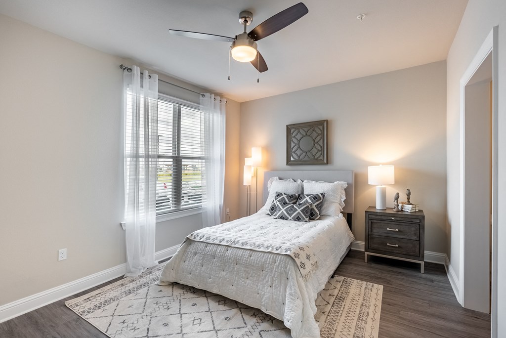 a bedroom with a bed and a ceiling fan
