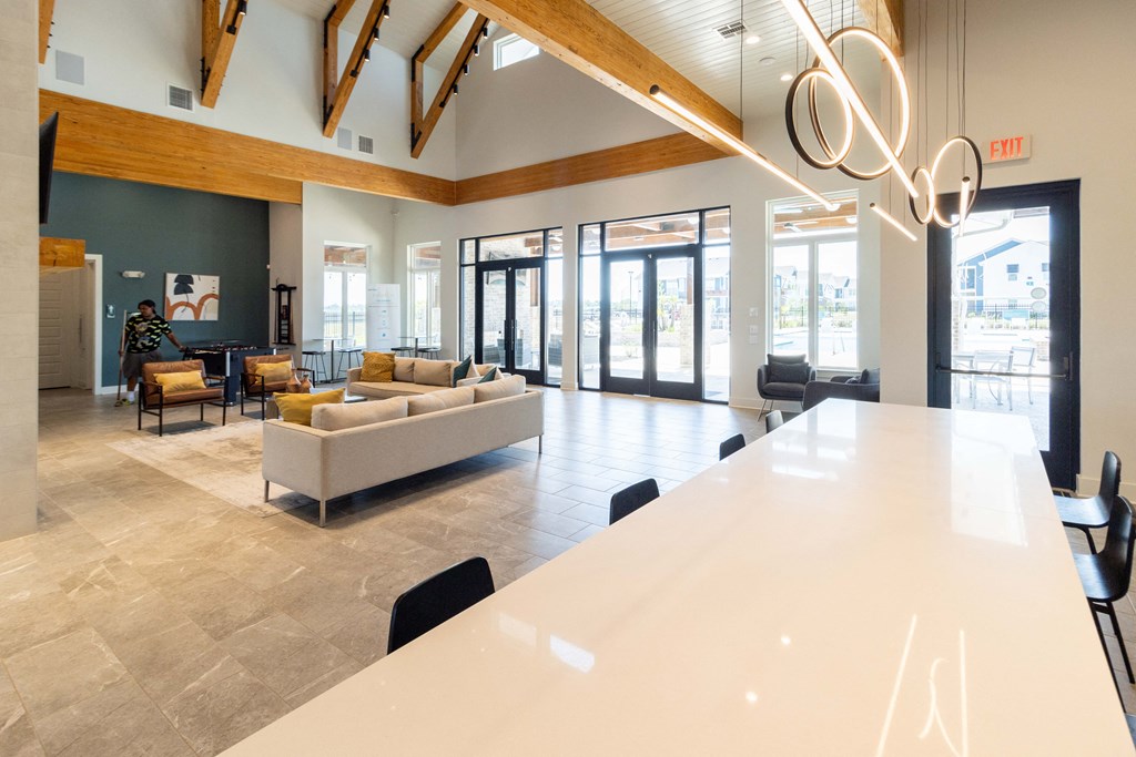 a large lobby with couches and chairs and a white table