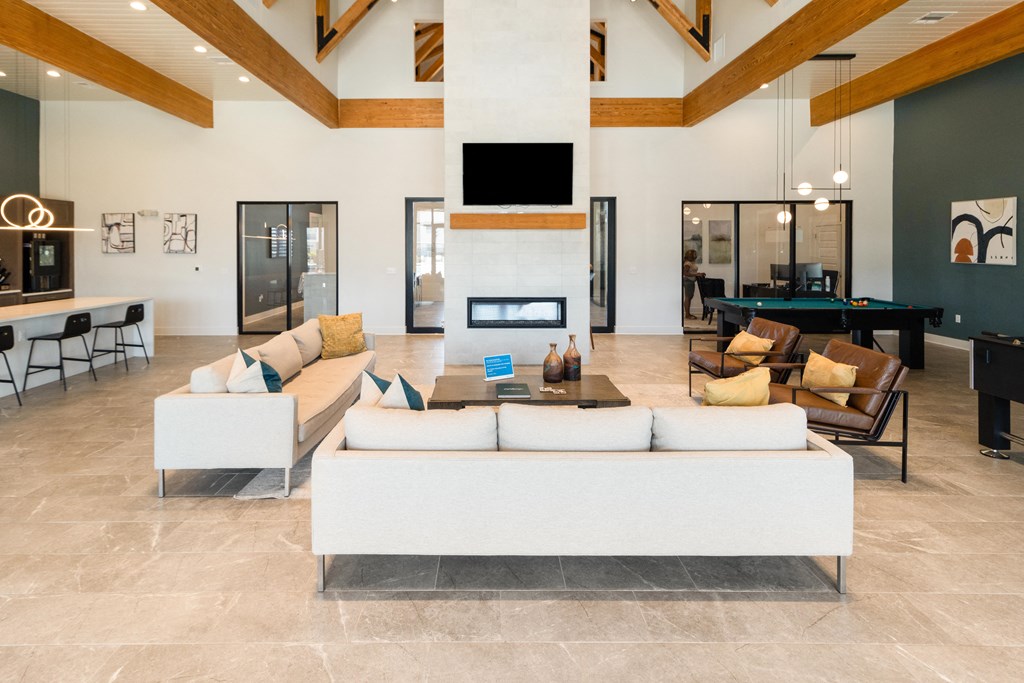 a living room with couches and a table and a fireplace