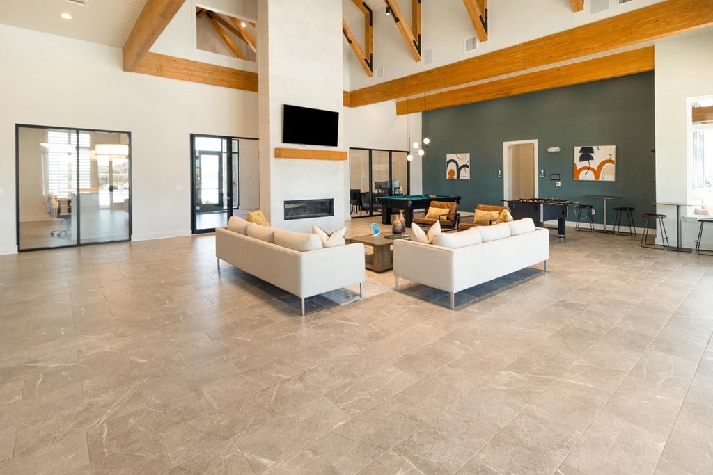 a large living room with couches and a fireplace