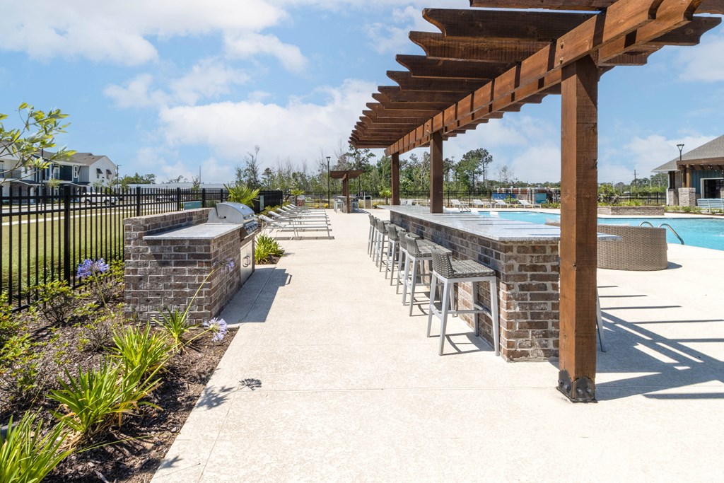 the pool area at the preserve at ballantyne commons has a patio with chairs