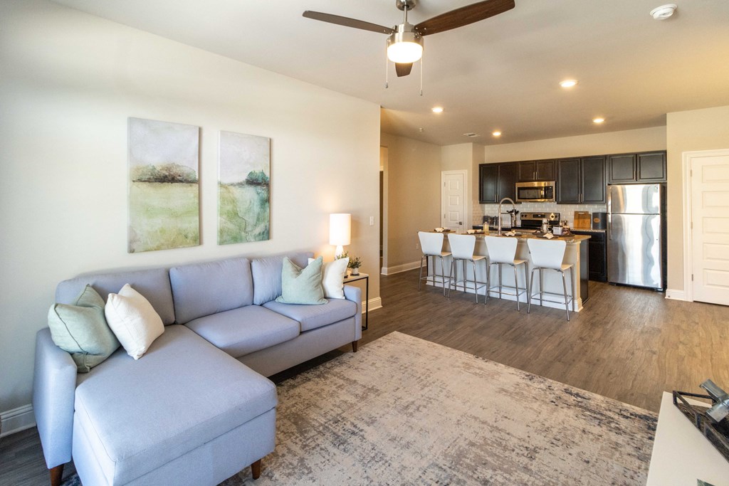 a living room with a couch and a kitchen