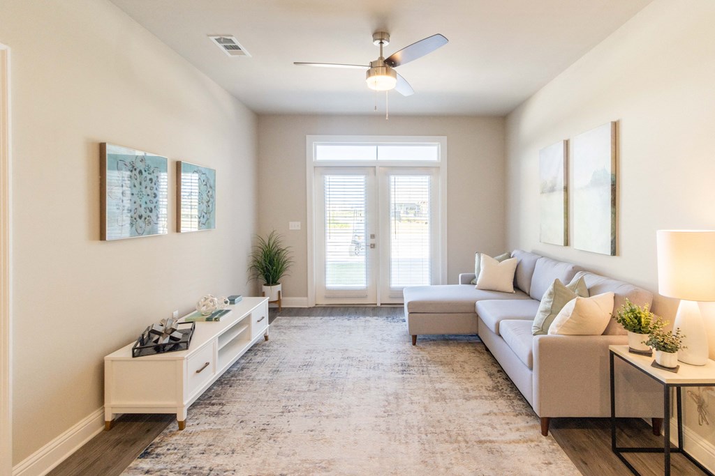 a living room with a couch and a ceiling fan