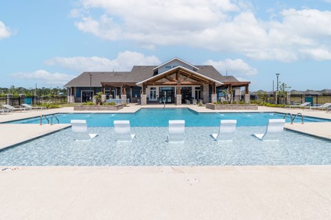 the pool at the preserve at ballantyne commons with a house in the background