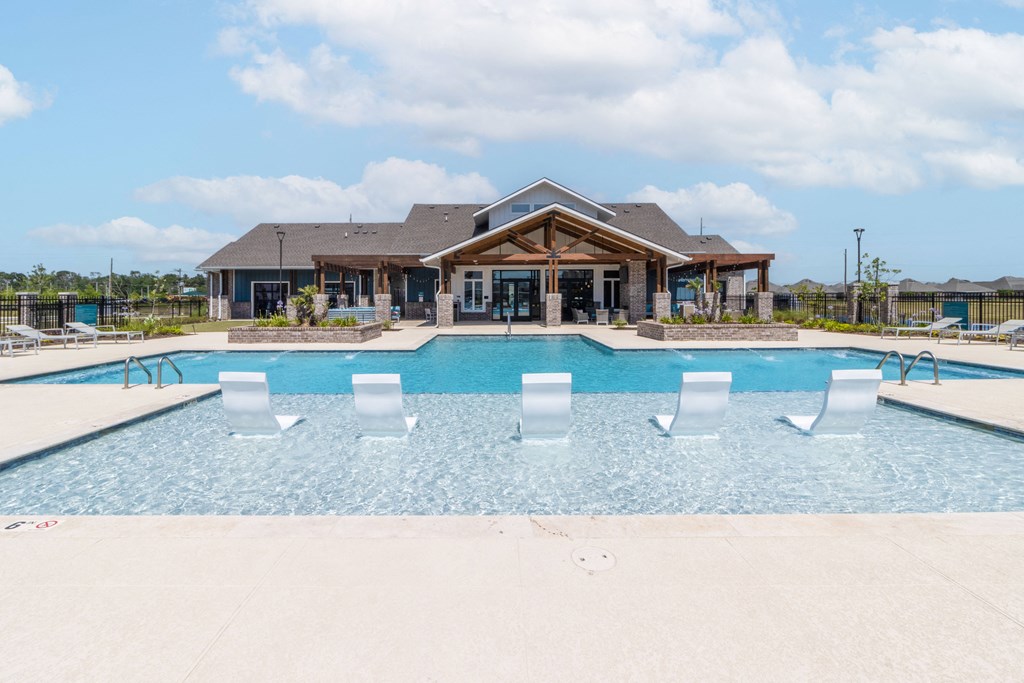 the pool at the preserve at ballantyne commons with a house in the background