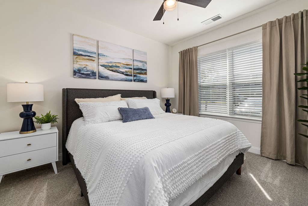 a bedroom with a large bed and a window