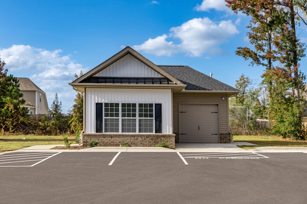 an empty parking lot in front of a house