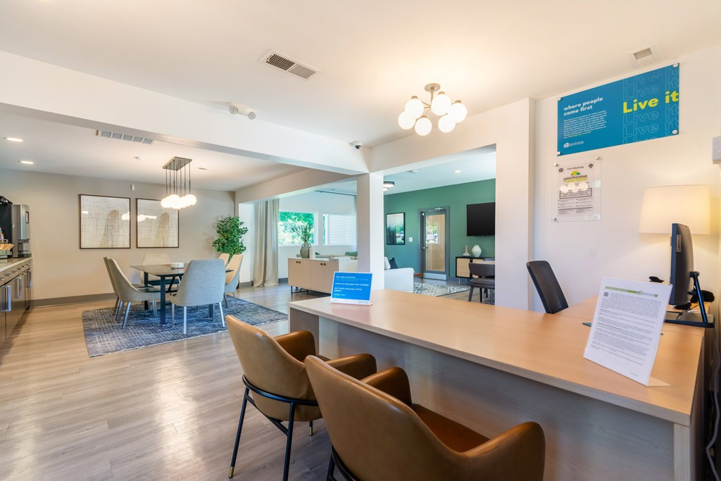 A reception area with a sign at Hawthorne at Oak Ridge in Greensboro, NC