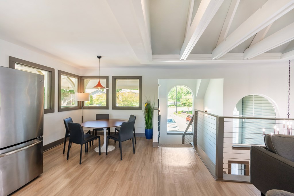 A clubhouse kitchen with a dining table and chairs at Hawthorne at Oak Ridge in Greensboro, NC.
