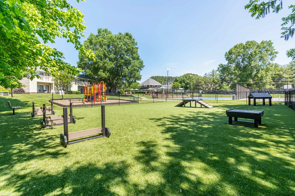 A park with a playground and picnic tables at Hawthorne at Oak Ridge in Greensboro, NC.