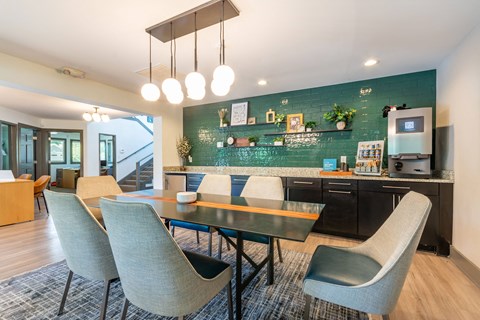 A modern kitchen with a dining table and chairs.
