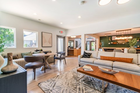 A living room with a white couch and a wooden coffee table.
