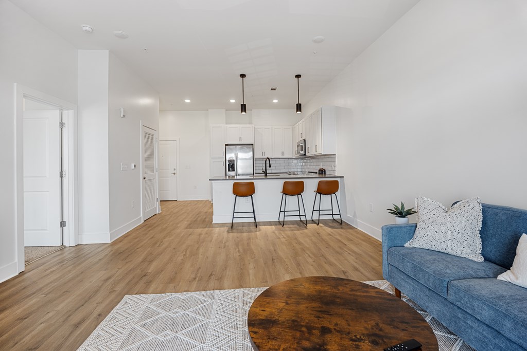 A Modern Living Room with a Bar Seating and a Couch.