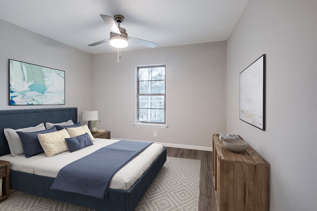 a bedroom with a large bed and a ceiling fan