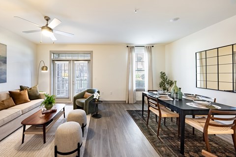 A modern living room with a dining table set for four.