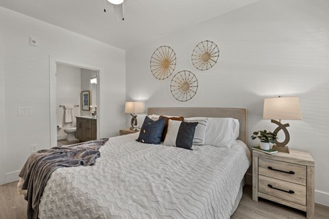 a bedroom with a bed and two clocks on the wall