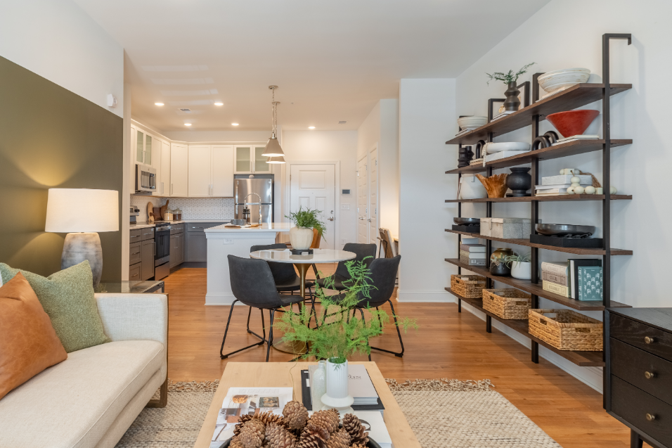 a living room and dining room with a kitchen and a table