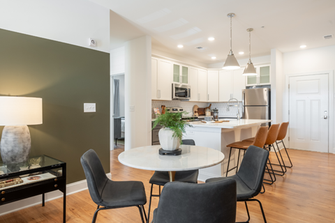 an open kitchen and dining room with a table and chairs