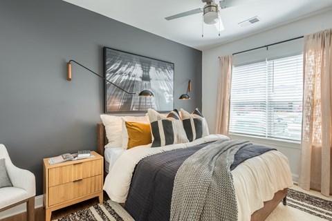 a bedroom with a bed and a ceiling fan