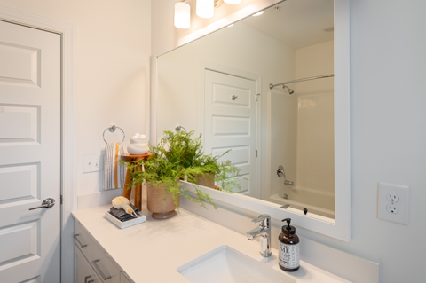 a white bathroom with a sink and a mirror