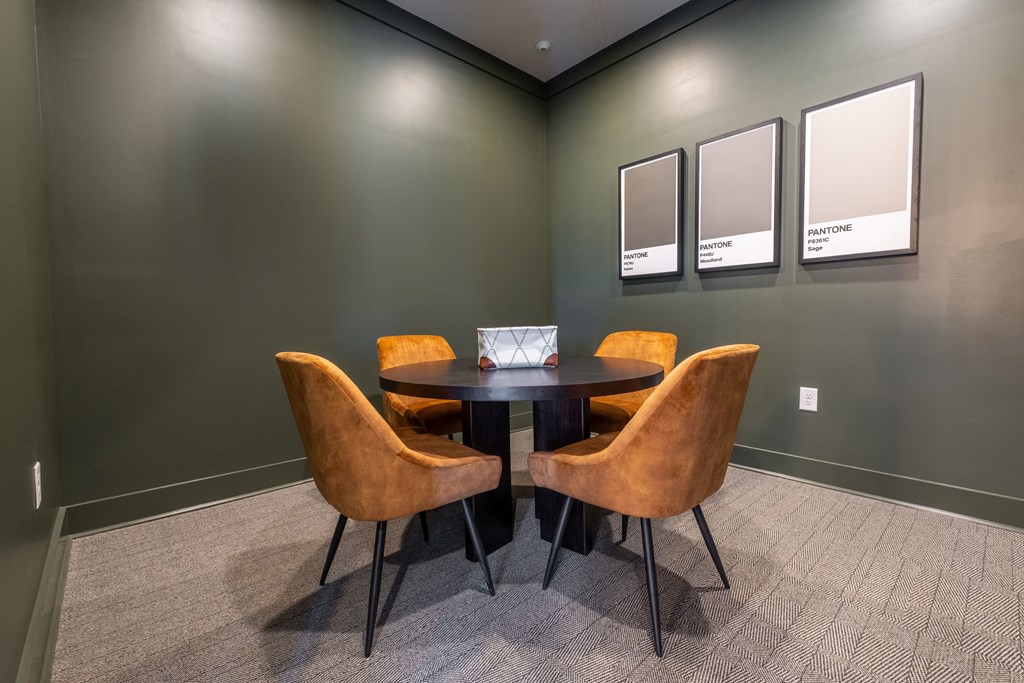 a conference room with a round table and chairs