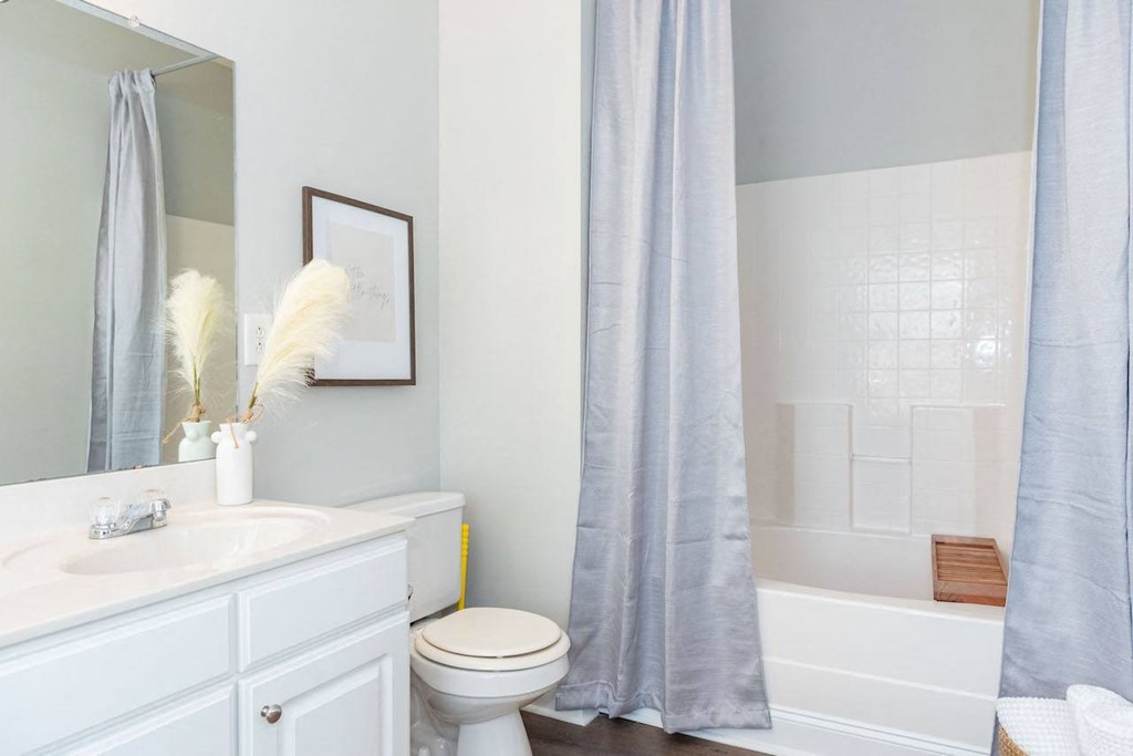 a bathroom with a sink toilet and a shower